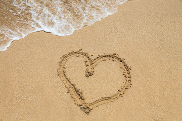 Heart symbol written in a sand