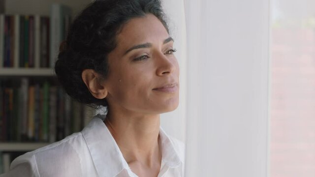 beautiful mixed race woman looking out window at home enjoying fresh new day feeling rested thinking planning ahead 4k footage