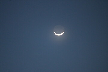 Day sky with moon and clouds