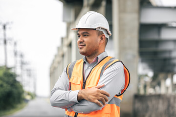 Asian engineer handsome man or architect looking construction with white safety helmet in...