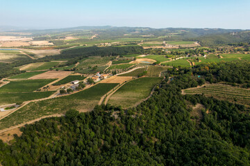 Obraz premium Landscape in Tuscany photographed with a drone. Fields, valley of Toscana, Siena region in Italy with roads, fields, forests and grape farms. Province of Siena Italy