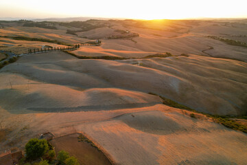 Beautiful idyllic late summer landscape of Toscana with plants, hills, trees and road. Sunny evening or morning in Italy. Vacation, recreation mood. Agricultural fields of Tuscany 