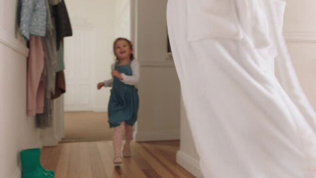 happy mother and daughter play catch running through house little girl playing game chasing mom enjoying fun weekend together 4k footage