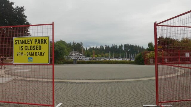 View of sign Stanley Park is Closed from 7pm to 9am daily following attacks by coyotes in Stanley Park