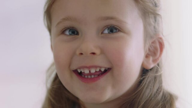 portrait happy little girl smiling with playful expression looking joyful child enjoying childhood 4k footage