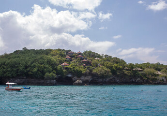 Obraz premium houses in a distant island and boats in water in Bali, Indonesia