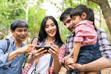 happy family with backpacks taking selfie by smartphone and hiking.Tourism, adventure and summer vacation concept