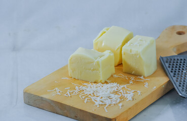 pieces of cheese on wooden board