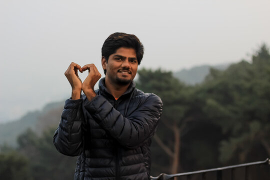 man in a park making a gesture from fingure 