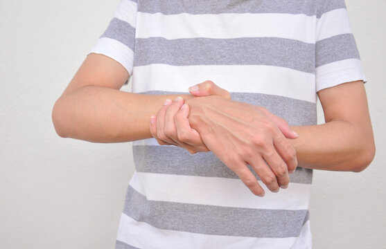 a man support his arms (selective focus) which pain,numbness,weakness,paralysis. concept of Guillain barre syndrome caused by autoimmune disorder