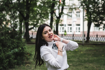 Stylish beautiful brunette girl in a summer city