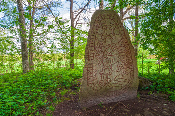 Olsbrostenen a beautifully decorated Runestone from the Viking Age in a forest