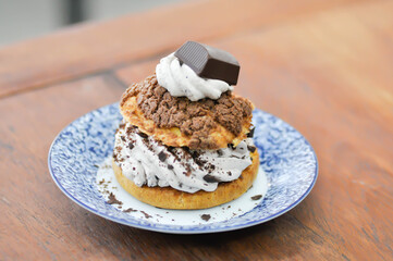 bun ,choux pastry with chocolate powder topping or eclair