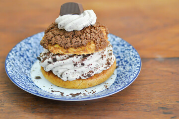 bun ,choux pastry with chocolate powder topping or eclair