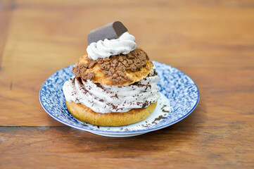 bun ,choux pastry with chocolate powder topping or eclair