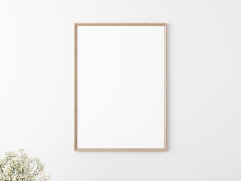 Blank rectangular wooden picture frame on white wall. Flower in corner. Place for your content. 3D illustration.