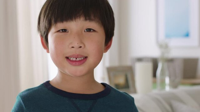 portrait of happy little asian boy smiling with playful expression enjoying fun positive childhood 4k footage