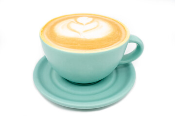 Close-up of cyan coffee cup, filled with coffee with milk foam and flower shaped decoration. White background