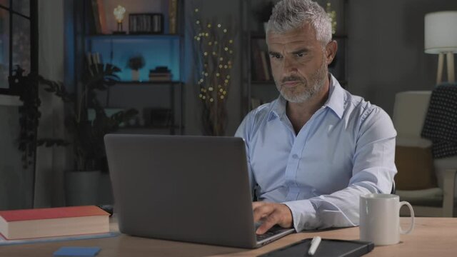 time lapse from day to night of busy overworked man working late at computer,mature caucasian male sits at his desk works from home at the laptop timelapse