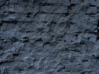 Brick wall painted with black paint