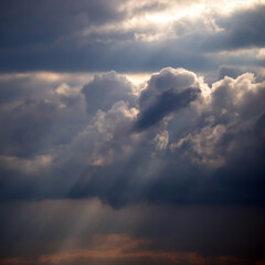 Fototapeta na wymiar Clouds, storm clouds and sunbeams before heavy rain.