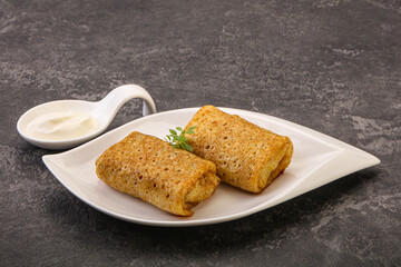 Staffed pancakes served sour cream