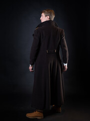character of the steampunk story, a young attractive man in an elegant long coat - 456339349