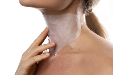Woman with a moisturizing and anti aging sheet mask applied on her neck - obrazy, fototapety, plakaty