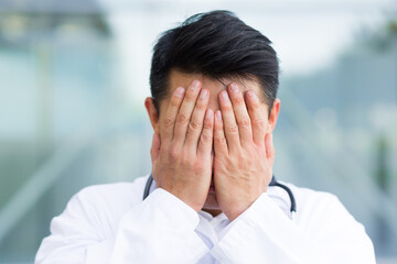 portrait of doctor asian man tired after work close up photo