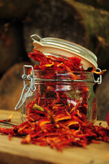  Dried peppers in a glass jar on a wooden background. Freeze-dried vegetables. The food is red. Dried spices healthy food. Spices.