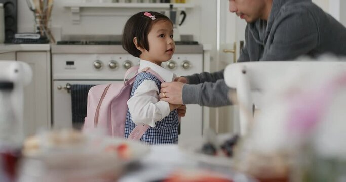 little asian girl getting ready for school happy father preparing daughter for first day kissing her on head saying goodbye 4k