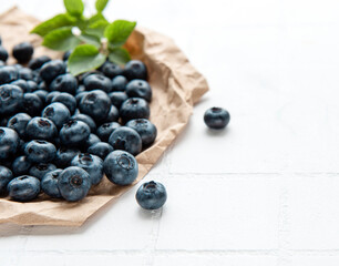 Blueberries on white tile  background