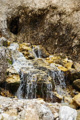 Fototapeta na wymiar small waterfall of pure water on the dolomites mountains