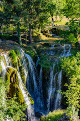 Beautiful small stream going into a romantic waterfall in lush greenery