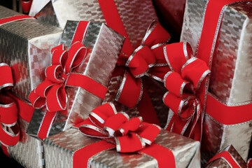 silver holiday packages with red bows 
