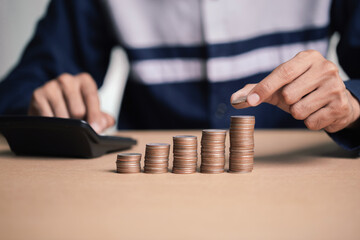 Saving money concept preset by Male hand putting money coin stack growing business