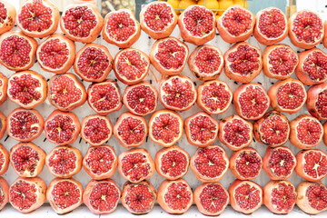 rows of ripe pomegranates ar the fruit market