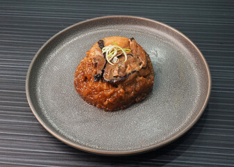 handmade steamed lomaigai sticky glutinous rice with chicken and mushroom on dark grey wood...