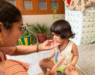 portrait of cute baby girl during haircutting.