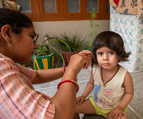 portrait of cute baby girl during haircutting.