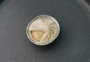 handmade steamed Shanghai Xiao long bao pork meat dumpling soup in plate on dark grey wood table asian dim sum halal food restaurant cuisine banquet menu for cafe