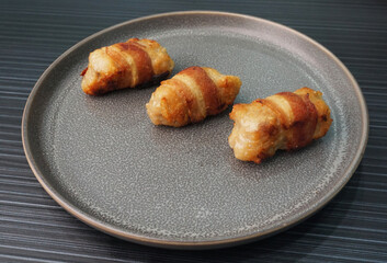 deep fried pork meatball wrapped with bacon roll on dark grey wood background dim sum menu