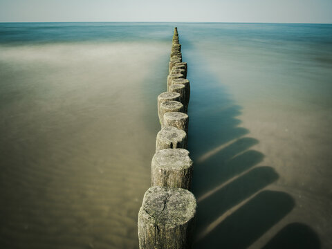 Wooden wave breaker at the beach