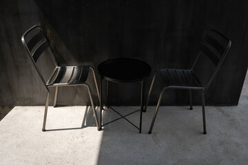 Set of chairs black steel frame on white cement floor with black wall background decoration for...