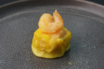 steamed fresh yellow stew mai dumpling wrapped with pork and prawn on dark grey wood background dim sum menu