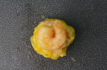 steamed fresh yellow stew mai dumpling wrapped with pork and prawn on dark grey wood background dim sum menu