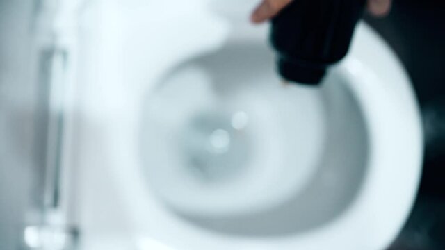 Pouring medical pills or capsules in a toilet, bad drug or useless medication concept