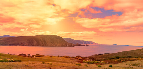 A beautiful coastal scene in the wilderness of Tasmania, Australia, with the spectacular evening cloud effects and the magical glow of the late sun just before sunset.