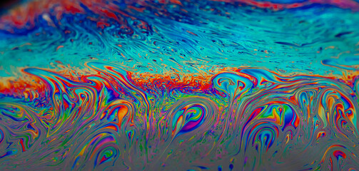 Abstract colourful background with patterns and rainbow effects in soap bubbles background.