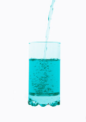 Water pouring into glass created bubbles isolated on white background.